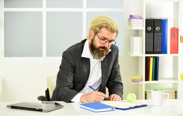 An accountant sitting at a desk with spread sheets.
